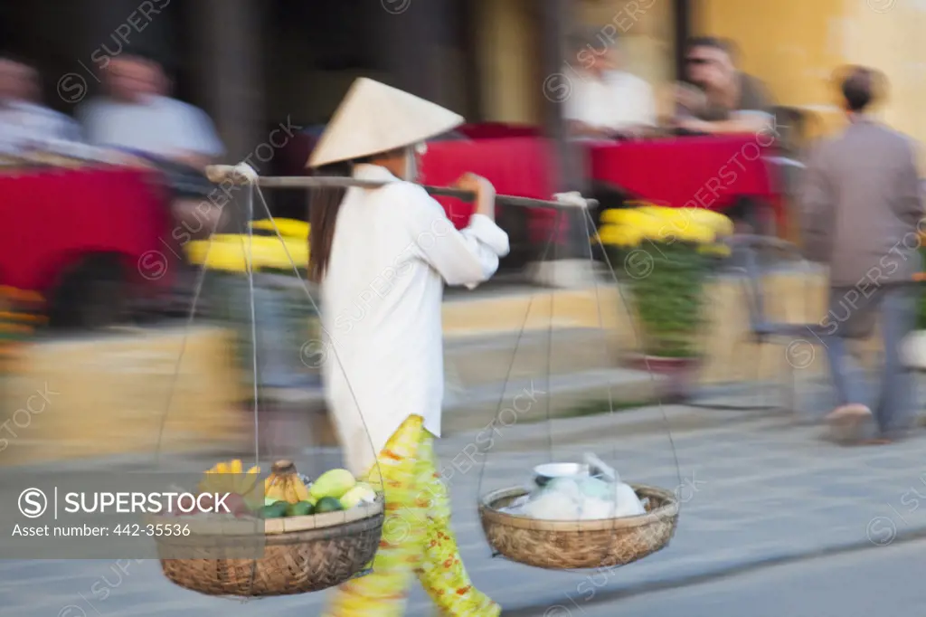 Woman selling fruits in a street, Hoi An, Vietnam