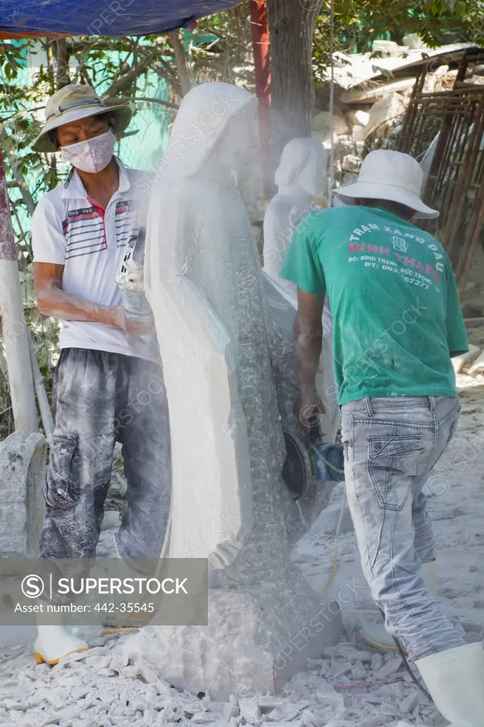 Workers carving a statue of Virgin Mary, Marble Mountain, Danang, Vietnam