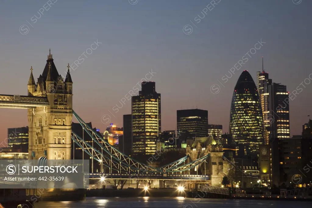 Bridge with buildings lit up at night, Tower Bridge, Thames River, London, England