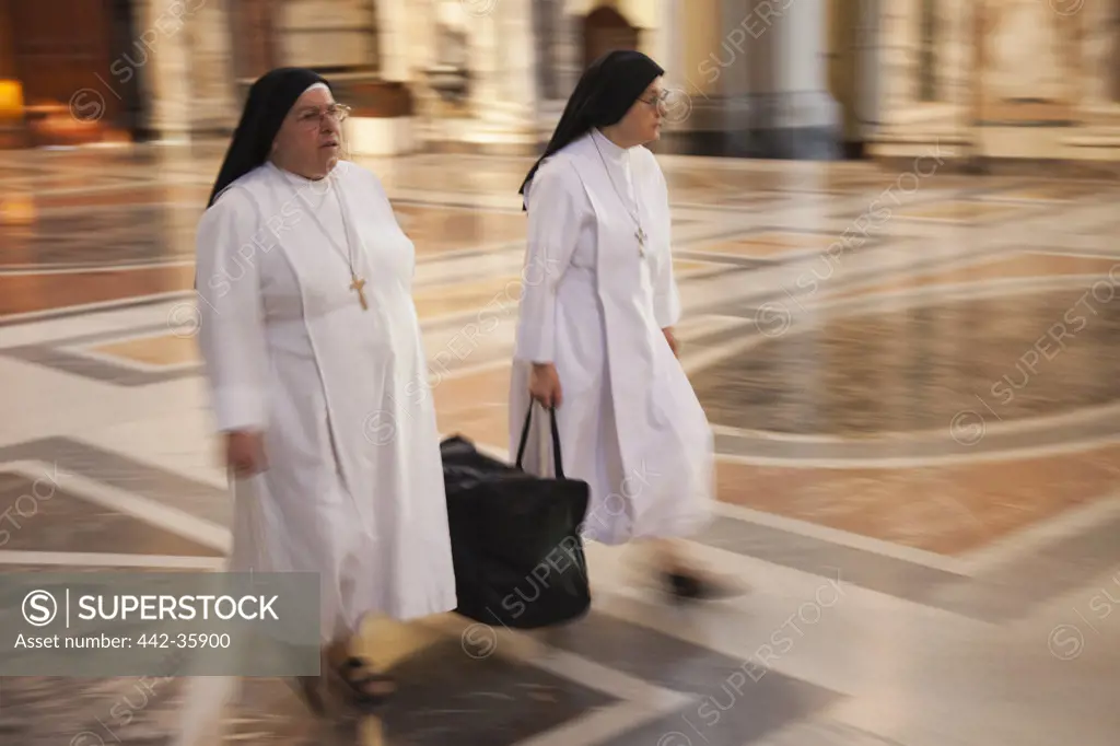 Italy, Rome, Two nuns walking in Basilica of St. John Lateran