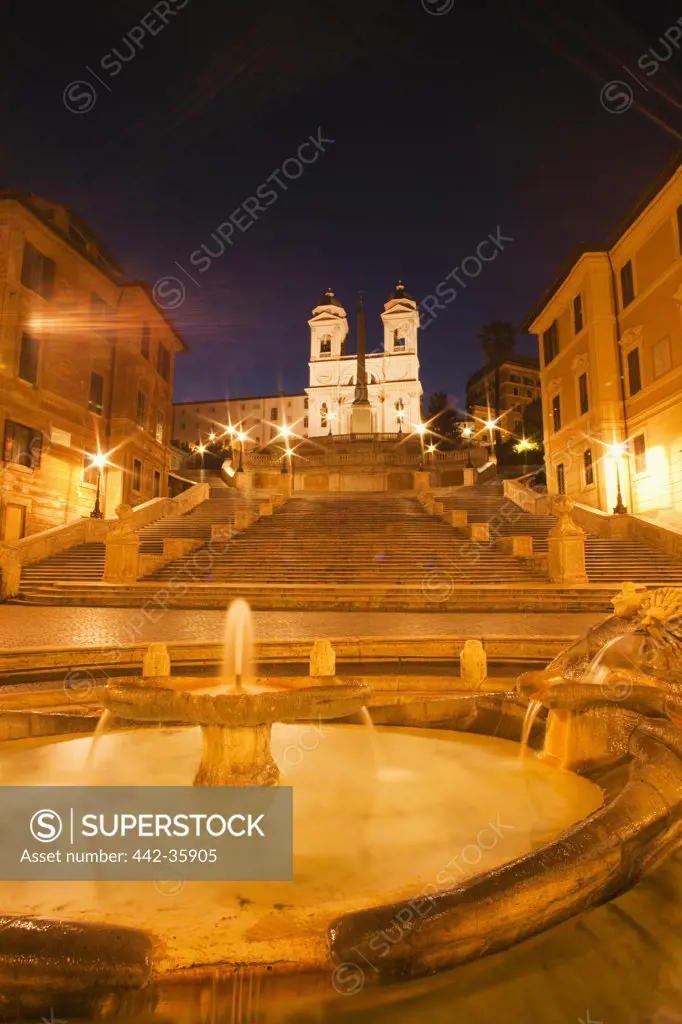 Italy, Rome, Fountain with Spanish Steps and Trinita dei Monti church illuminated at night