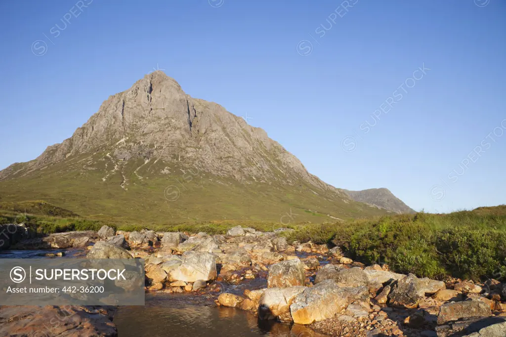 Rock formations with mountain in the background, Buachaille Etive Mor, Glencoe, Highlands Region, Scotland