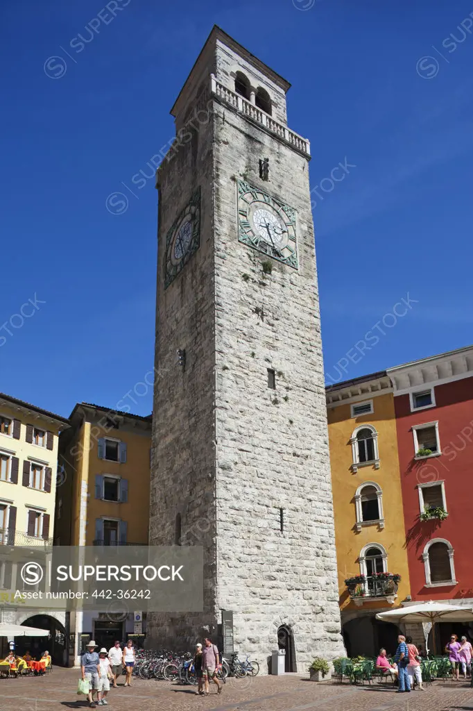 Tourists near a clock tower, Apponale Tower, Riva del Garda, Lake Garda, Trento, Italy