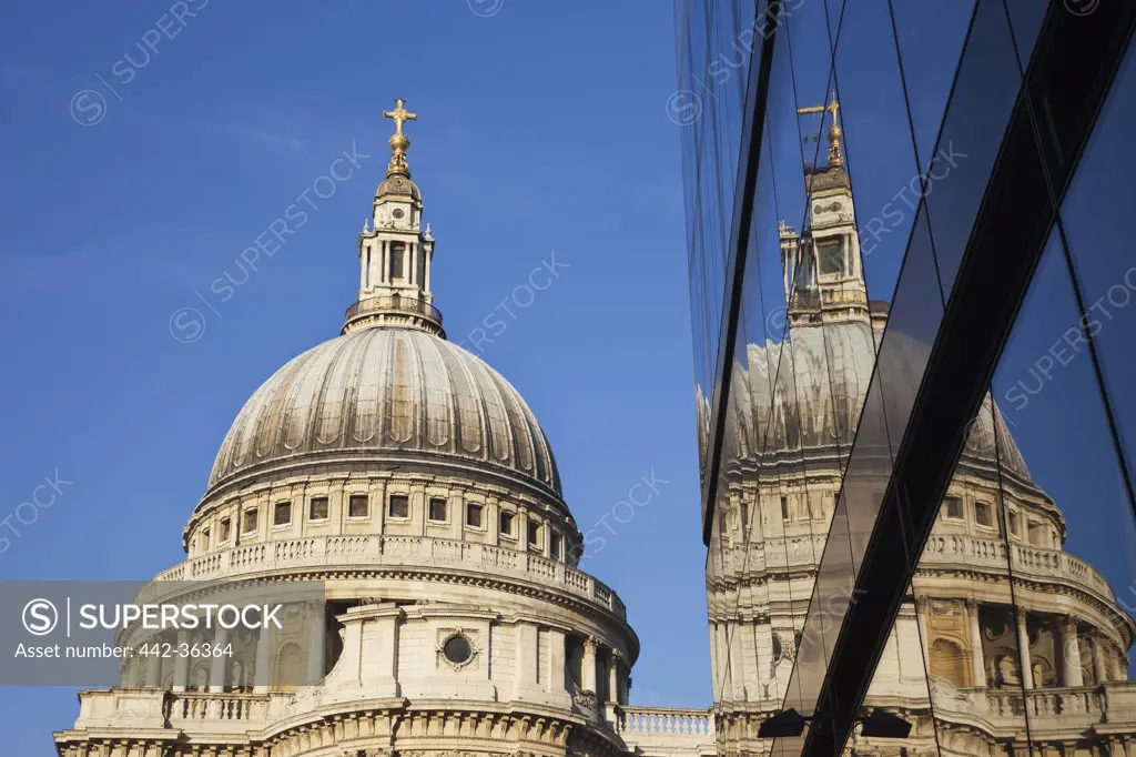 Reflection of St. Paul's Cathedral on glass building, City of London, London, England