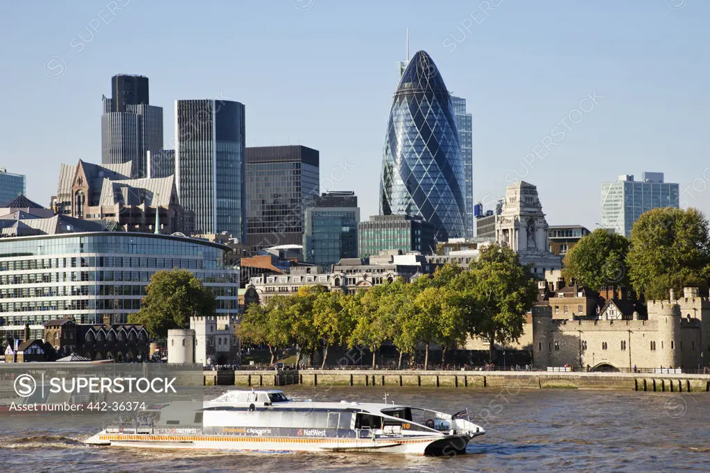 Tourboat in the river with office buildings in the background, City of London, London, England