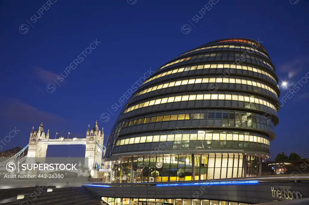 City Hall lit up at night with the Tower Bridge in the background, Southwark, London, England