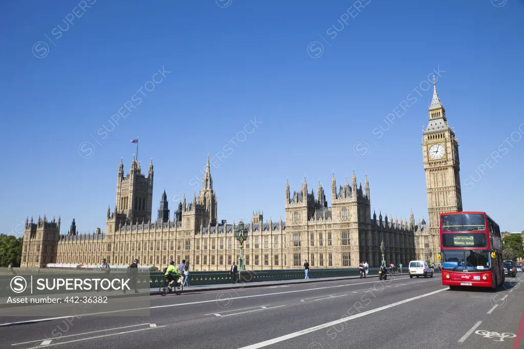 Bus on the road with the Houses of Parliament and the Big Ben in the background, City Of Westminster, London, England