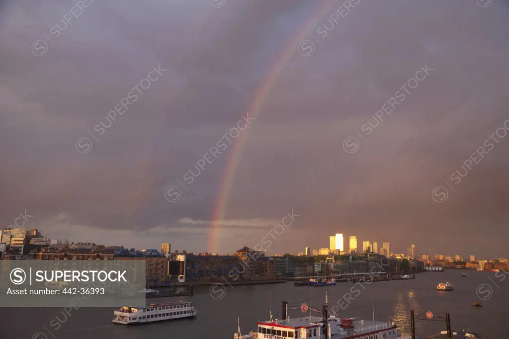 Rainbow over Docklands skyline and Thames River, Docklands, London, England