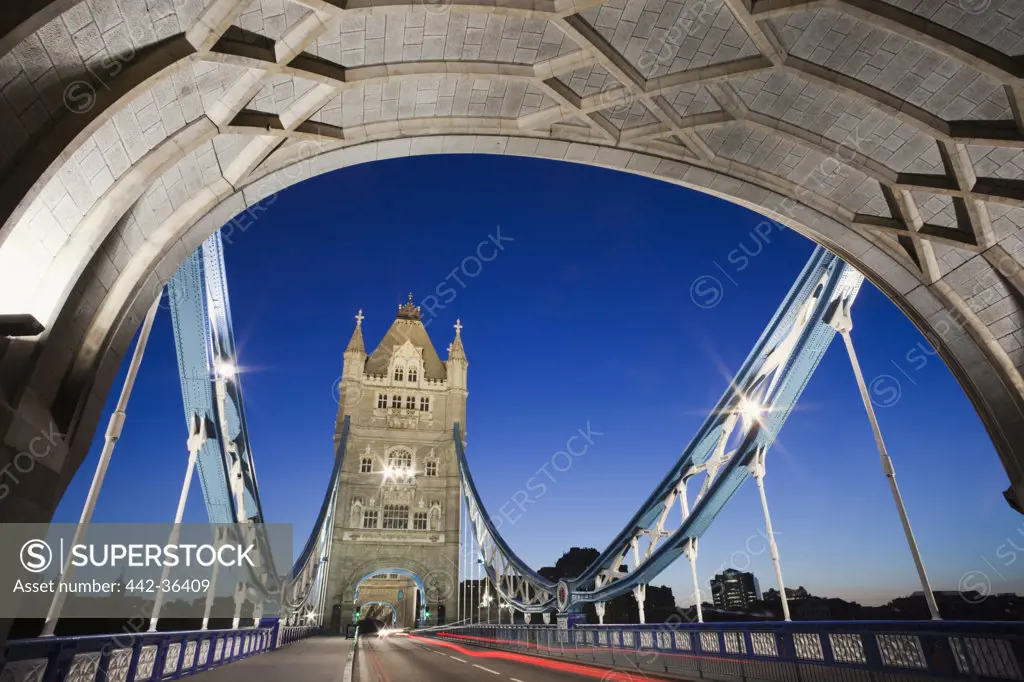Tower Bridge lit up at night, Thames River, London, England