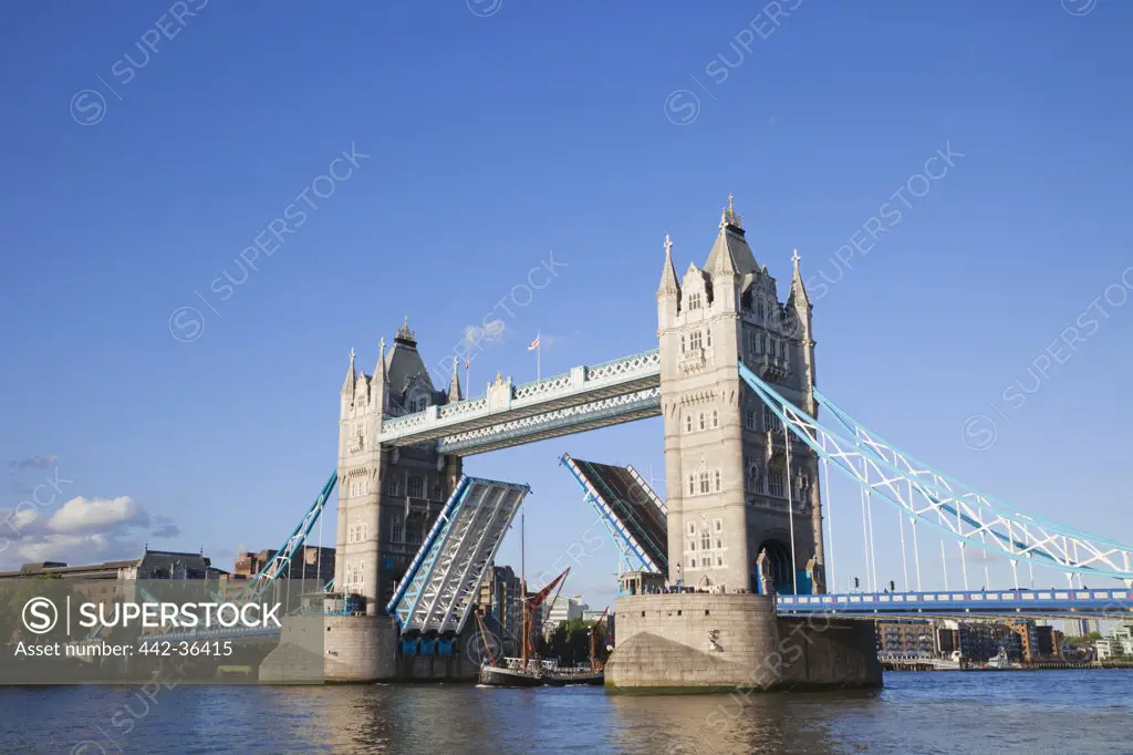 Bridge lifting to let through a boat, Tower Bridge, Thames River, London, England