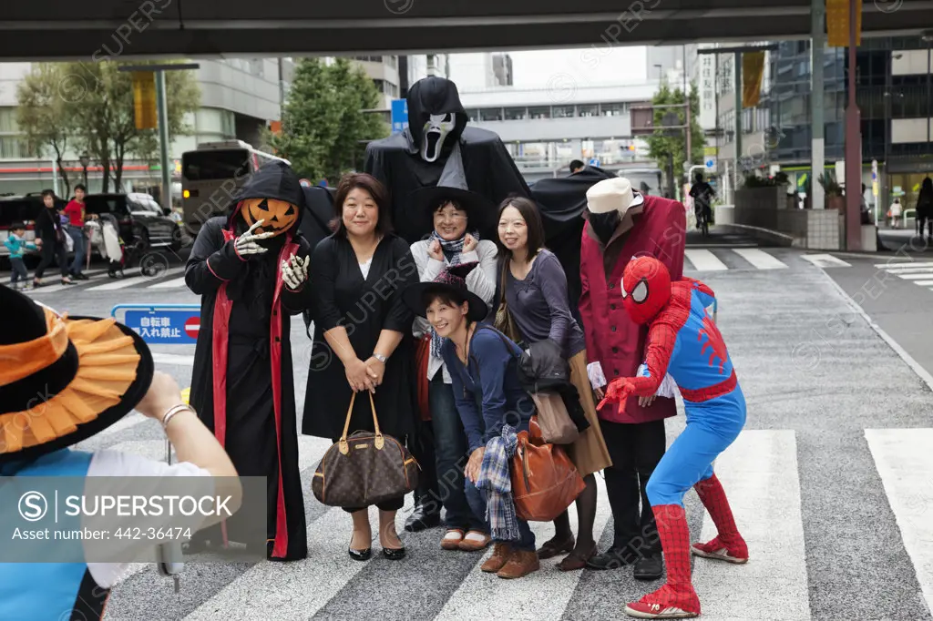 Shoppers posing with Halloween costumed characters, Ginza, Tokyo, Japan
