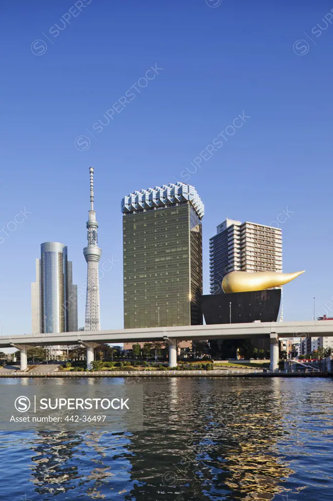 Tokyo Sky Tree and business area skyline at the waterfront, Sumida River, Asakusa, Tokyo, Japan