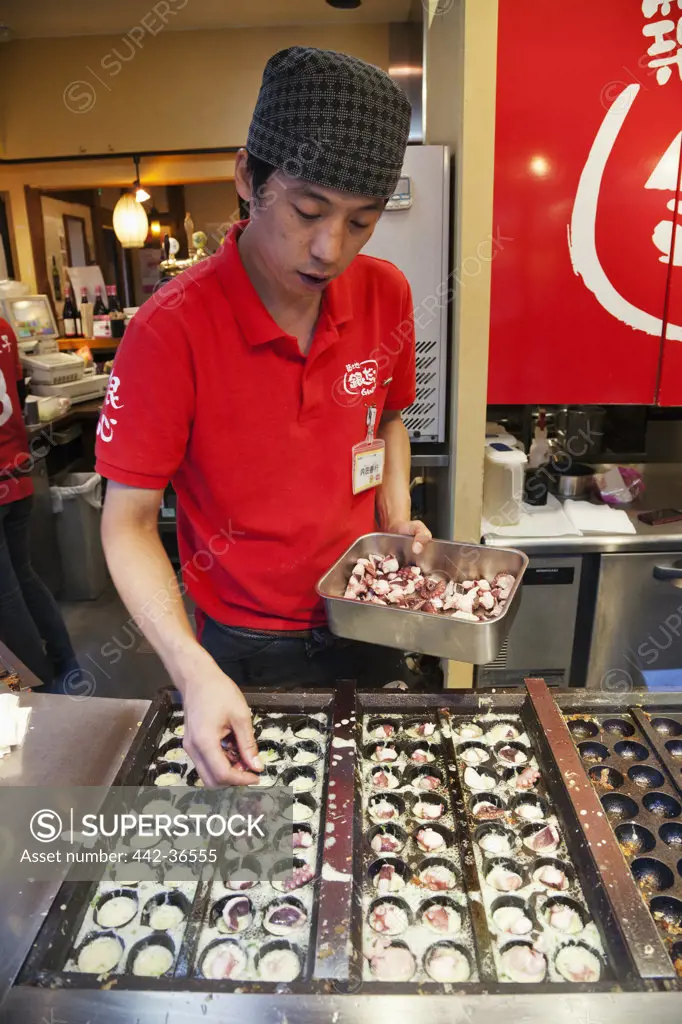 Man cooking Japanese fast food, Shinjuku Ward, Tokyo, Japan