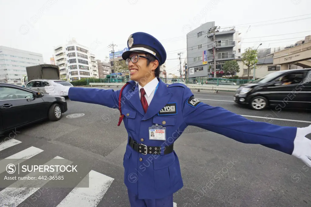 Parking attendant controlling traffic, Tokyo, Japan