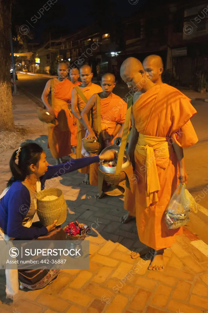 Monks receiving alms, Vientiane, Laos