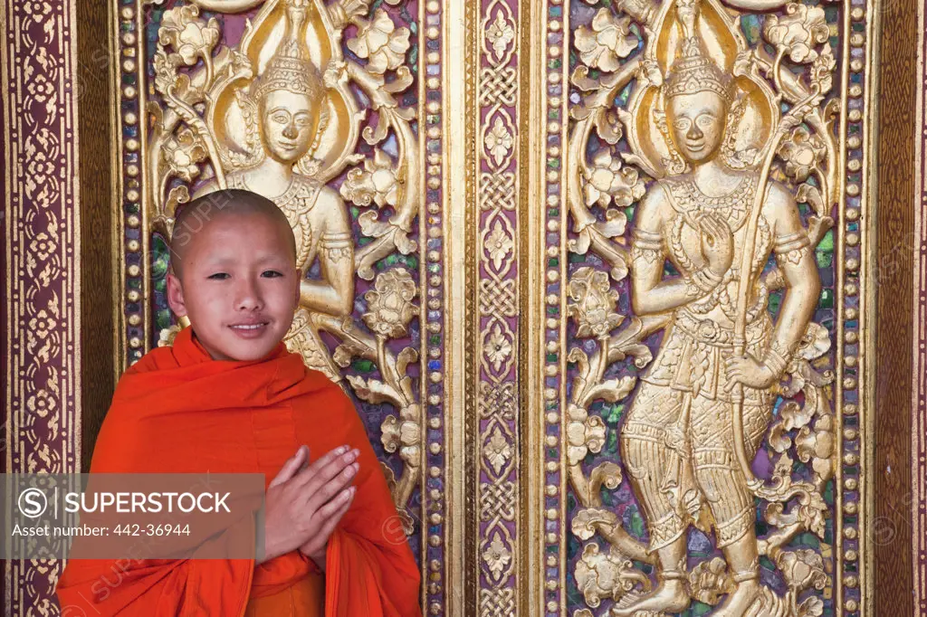 Monk at main prayer hall doorway, Wat Sensoukarahm, Luang Phabang, Laos