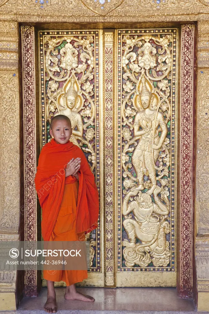 Monk at main prayer hall doorway, Wat Sensoukarahm, Luang Phabang, Laos