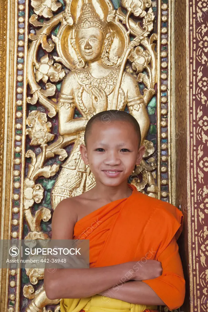 Portrait of monk at main prayer hall doorway, Wat Sensoukarahm, Luang Phabang, Laos