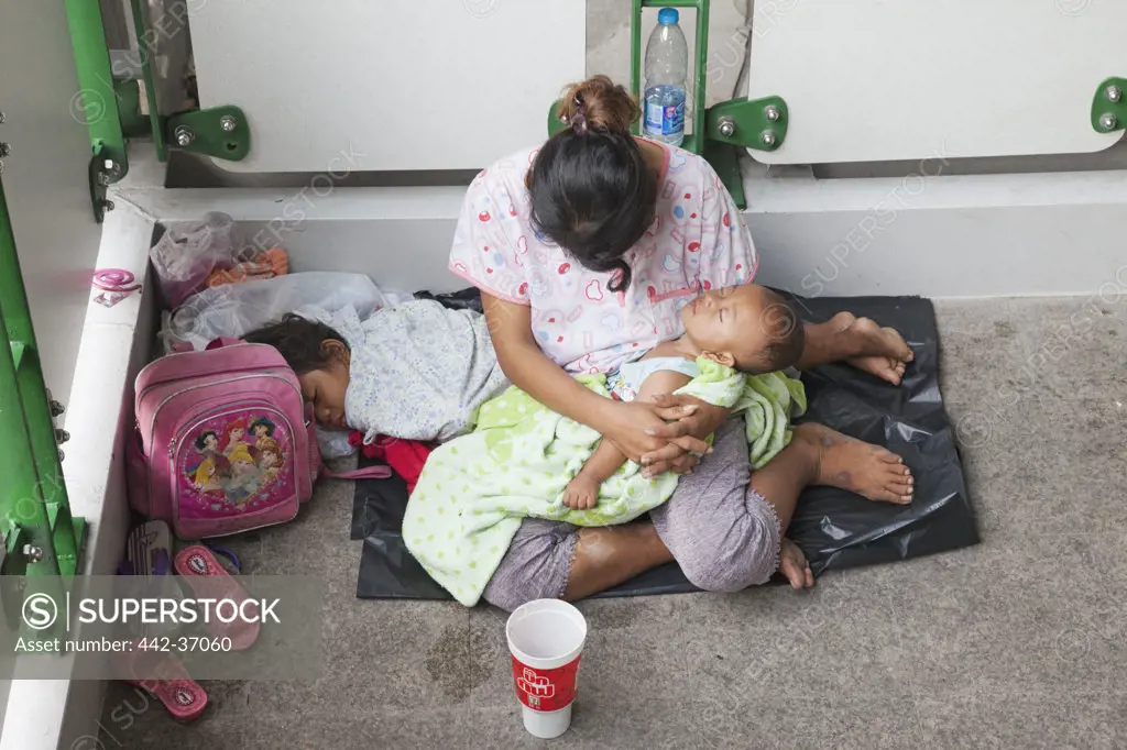 Homeless woman begging with her children, Bangkok, Thailand