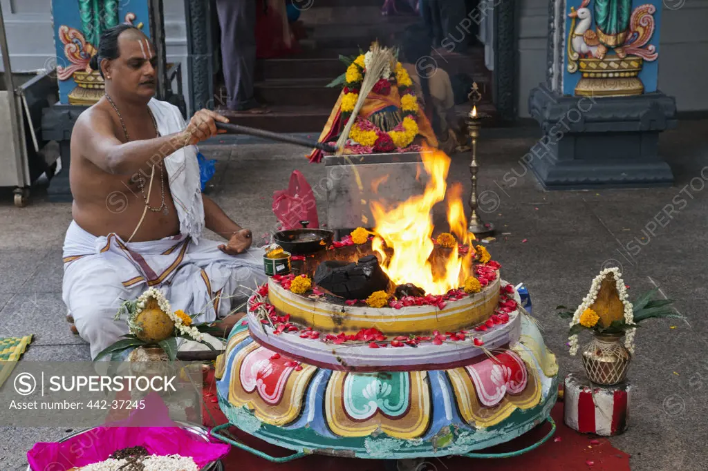 Priest performing Yajna (a Hindu ritual) outside a temple, Sri Srinivasa Perumal Temple, Little India, Singapore