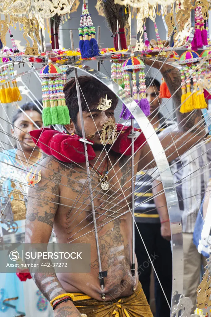 Devotee with pierced body in a religious procession at Thaipusam Festival, Sri Srinivasa Perumal Temple, Little India, Singapore