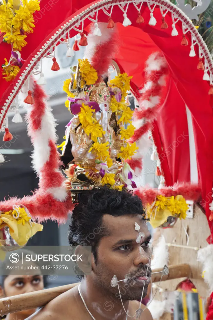 Devotee with pierced body in a religious procession at Thaipusam Festival, Sri Srinivasa Perumal Temple, Little India, Singapore