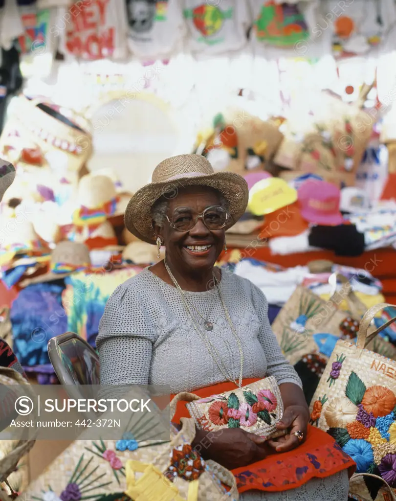 Portrait of a female vendor sitting in a straw market, Nassau, Bahamas
