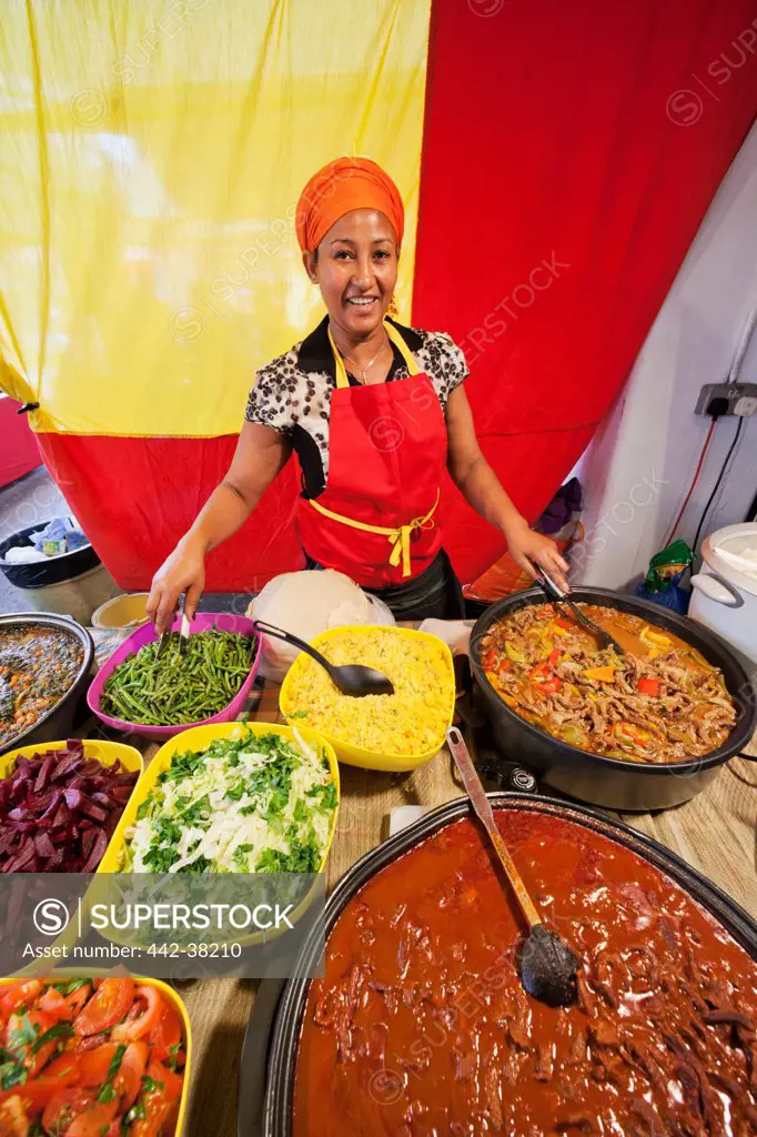 UK, London, Whitechapel, Spitalfields Market, Seller at stall with Ethiopian Food