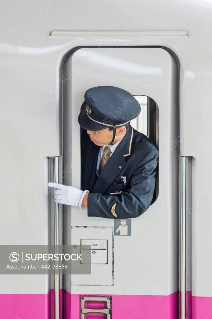 Japan, Honshu, Kanto, Tokyo, Tokyo Station, Train Guard And Door Of Shinkansen Bullet Train