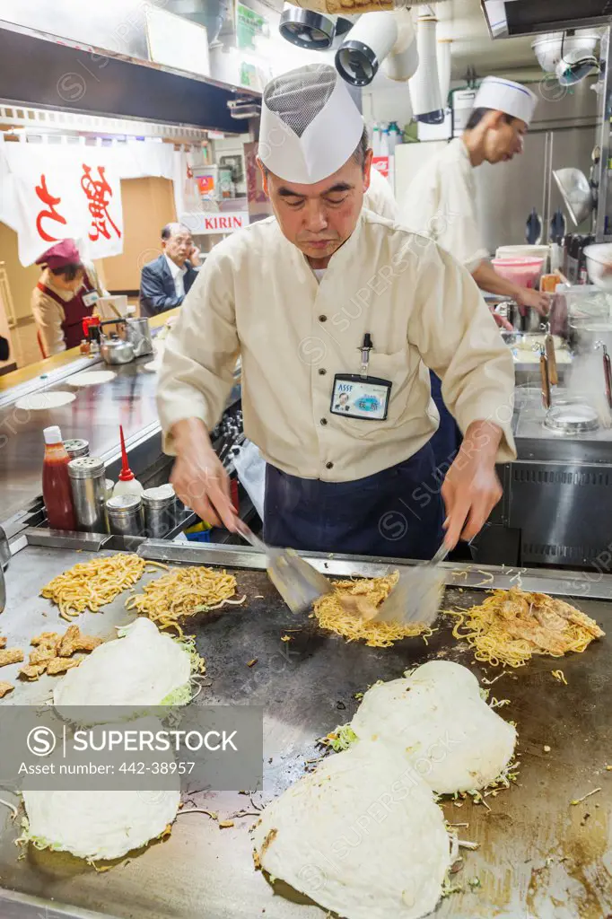 Japan, Kyushu, Hiroshima, Chef Cooking Okonomiyaki