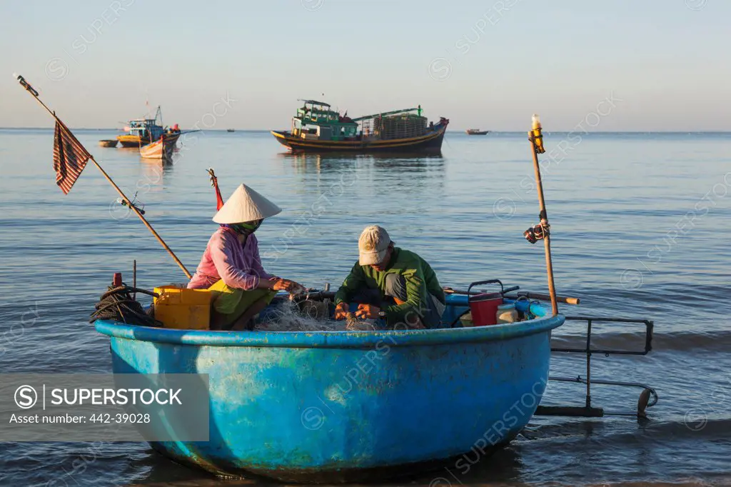 Vietnam, Mui Ne, Mui Ne Beach, Fishermen with Coracle Fishing Boats