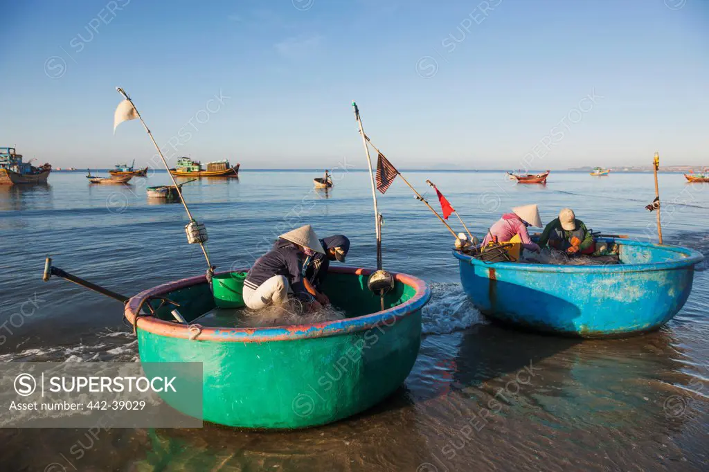 Vietnam, Mui Ne, Mui Ne Beach, Fishermen with Coracle Fishing Boats
