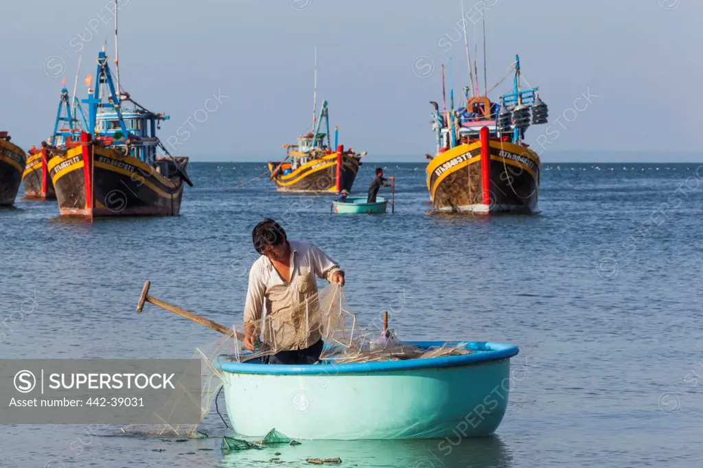 Vietnam, Mui Ne, Mui Ne Beach, Fisherman in Coracle Fishing Boat
