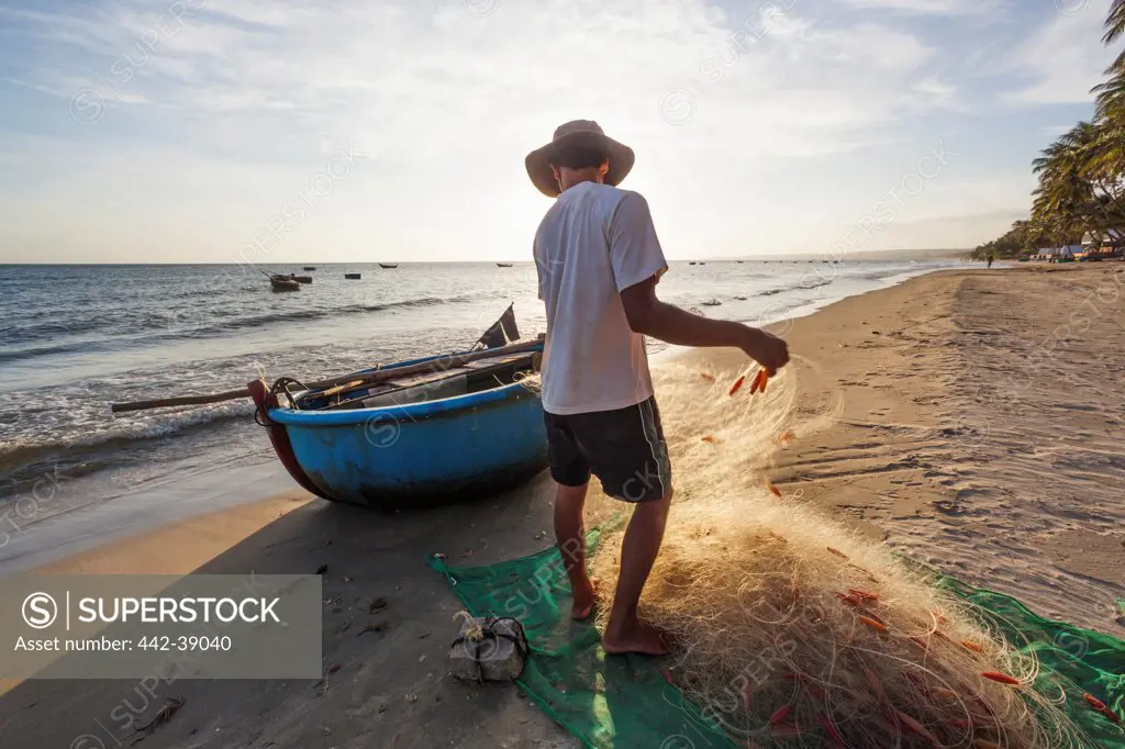 Vietnam, Mui Ne, Mui Ne Beach, Fishermen and Coracle Fishing Boat