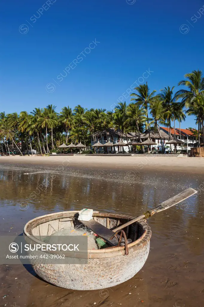 Vietnam, Mui Ne, Mui Ne Beach, Coracle Fishing Boat and Palm Trees