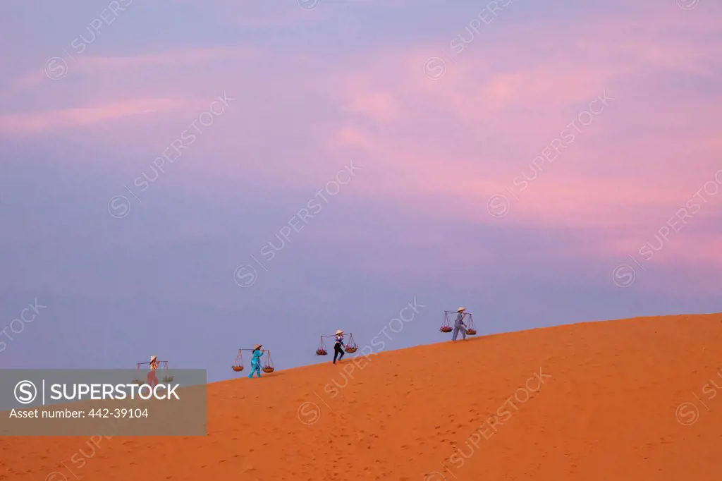 Vietnam, Mui Ne, Sand Dunes, Local Women in Conical Hats at Dawn