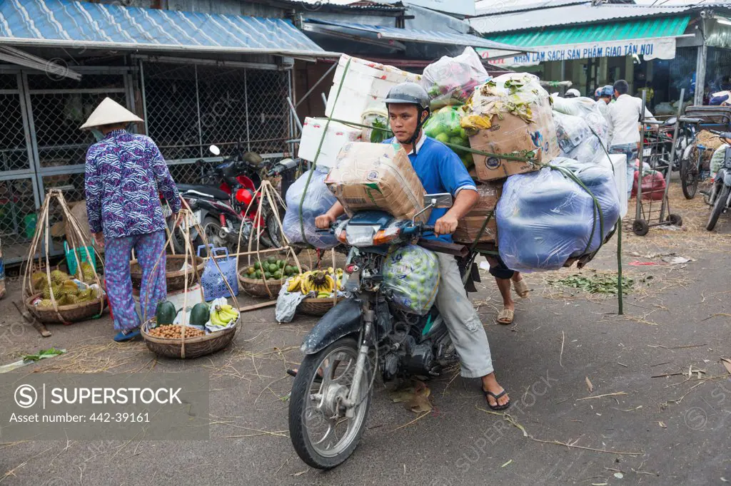 Vietnam, Nha Trang, Dam Market, Overloaded motorcycle transporting goods