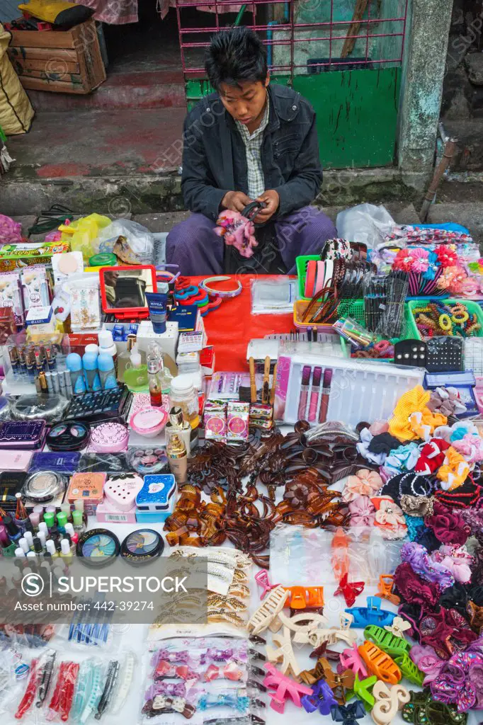 Vendor selling female beauty accessories at street market, Yangon, Myanmar