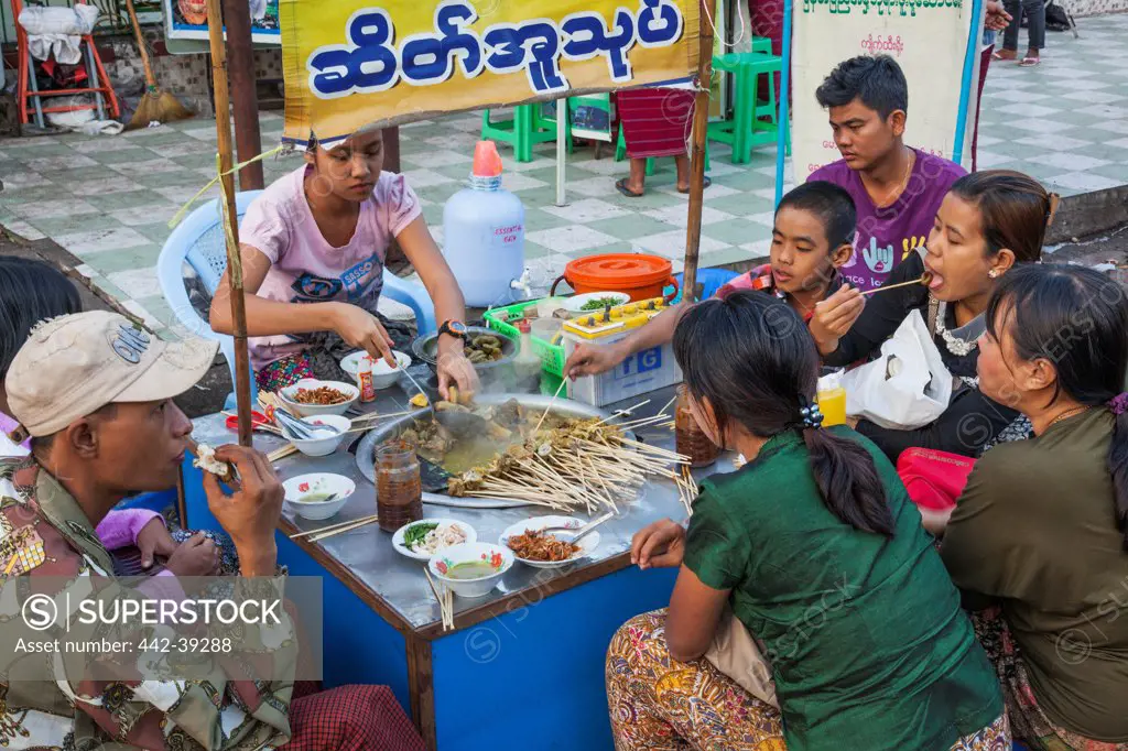 People having food at a roadside restaurant, Yangon, Myanmar