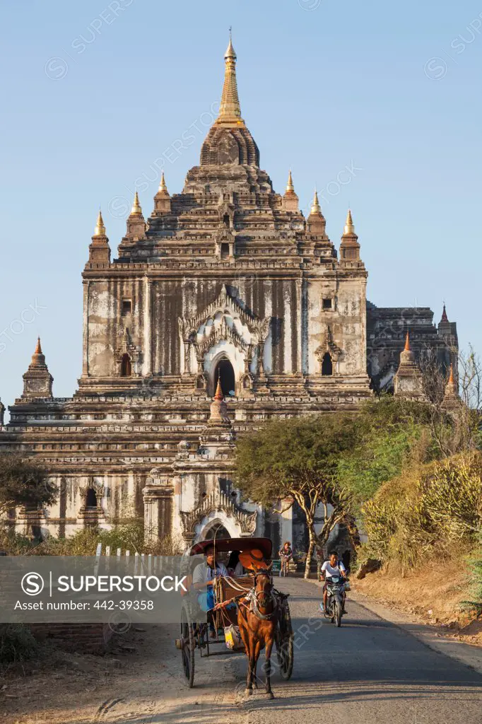Tourists outside a temple, Thatbinnyu Temple, Bagan, Myanmar