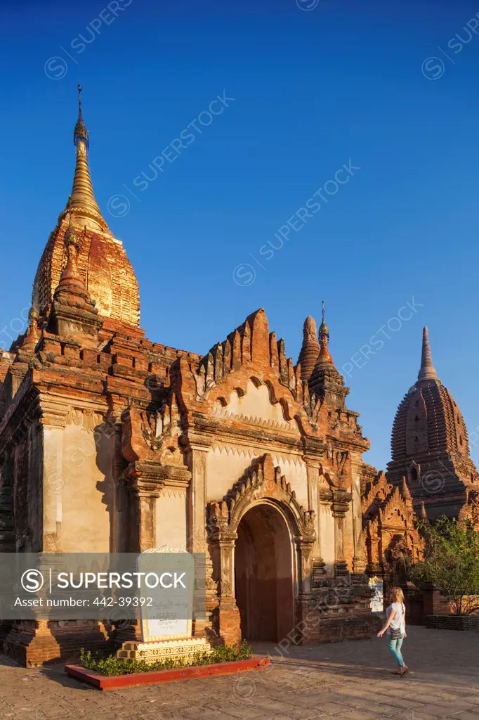 Woman walking outside a temple, Bagan, Myanmar
