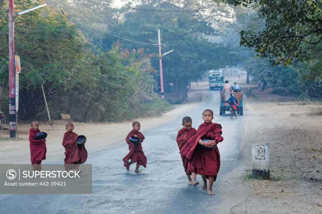 Young monks crossing a road, Bagan, Myanmar