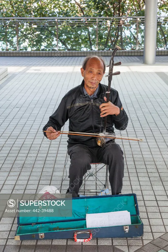China, Hong Kong, Elderly Busker Playing Chinese Erhu Instrument