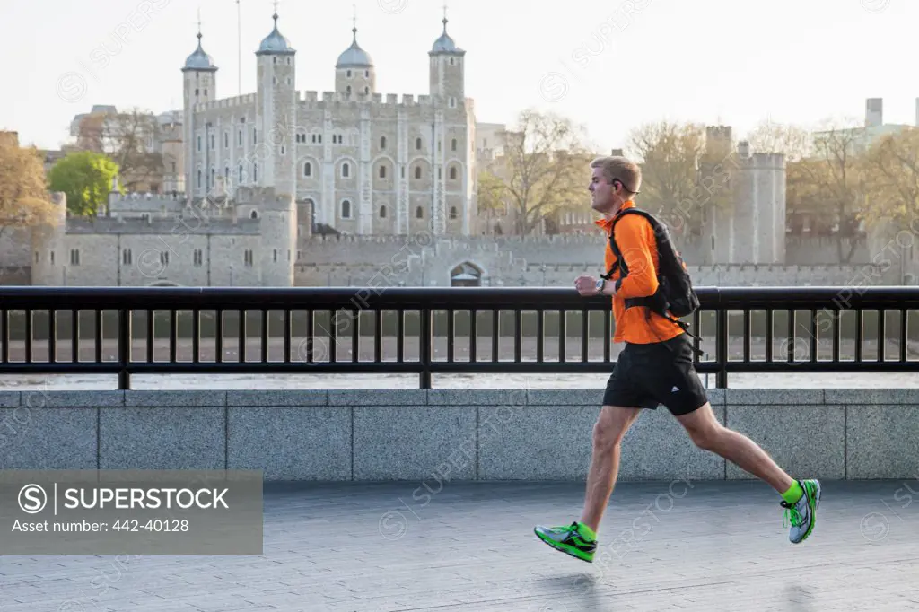 UK, England, London, Southwark, Jogger and Tower of London in background