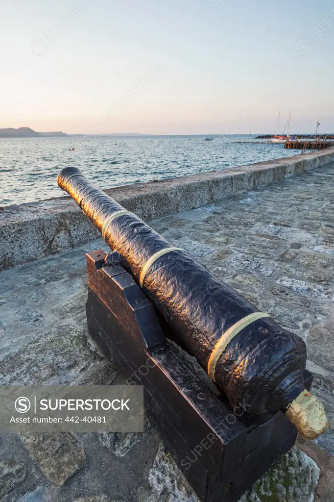 Cannon on a jetty, The Cobb, Lyme Regis, Dorset, England