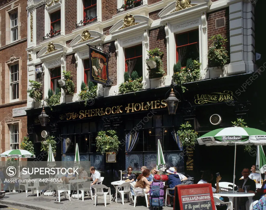 Group of people sitting at a sidewalk cafe, Sherlock Holmes Pub, London, England