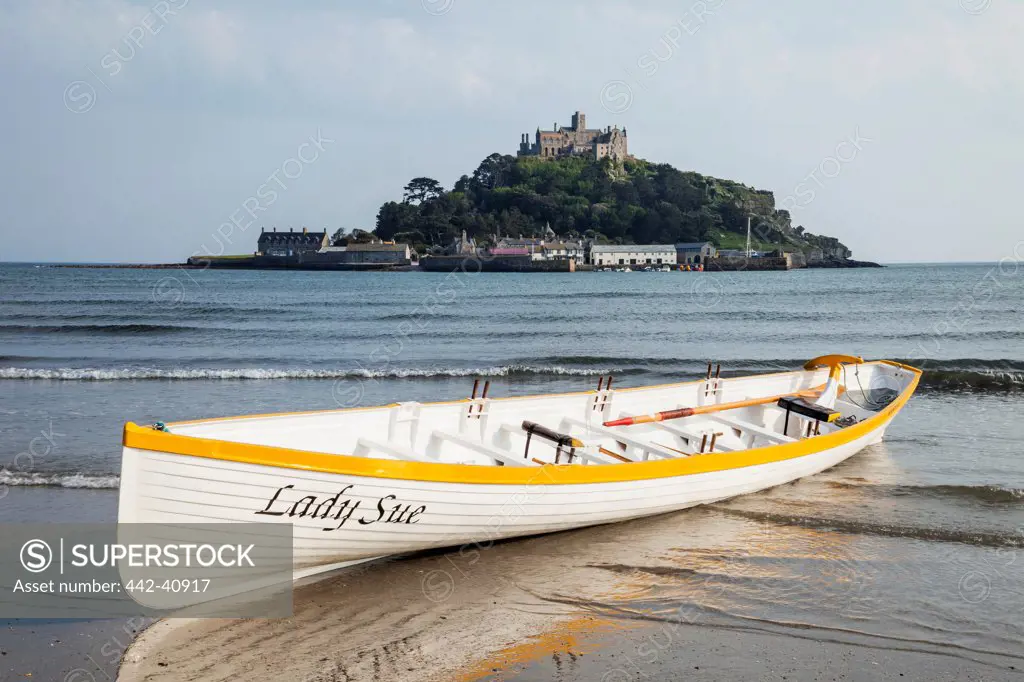 Boat on the beach with island in the background, St. Michael's Mount, Marazion, Cornwall, England