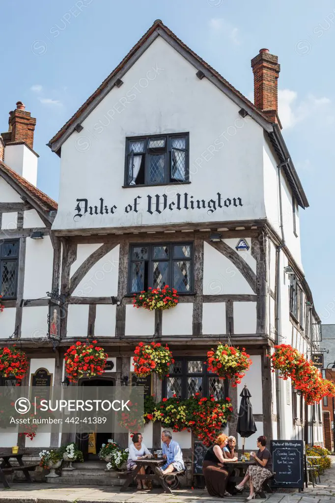 Tourists sitting outside a pub, Duke of Wellington, Southampton, Hampshire, England