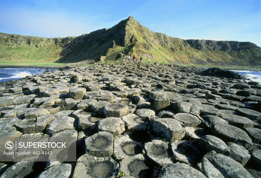 Tourists on volcanic rocks, Giant's Causeway, County Antrim, Northern Ireland