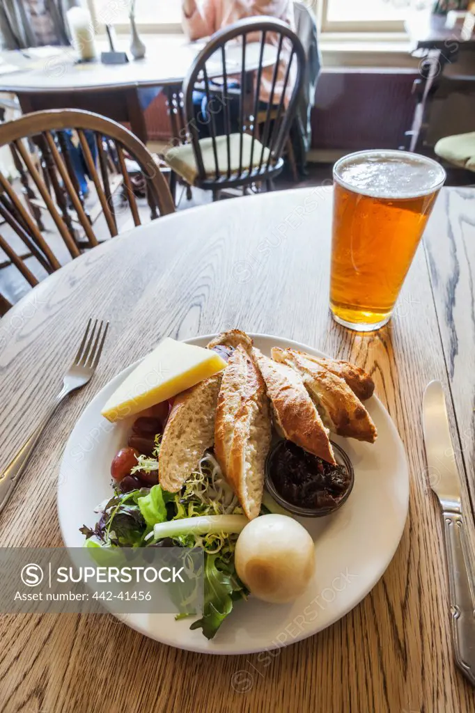 Ploughmans lunch with beer on a table in a pub, England